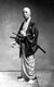 Japan: Samurai with folded fan and twin swords, c. 1870